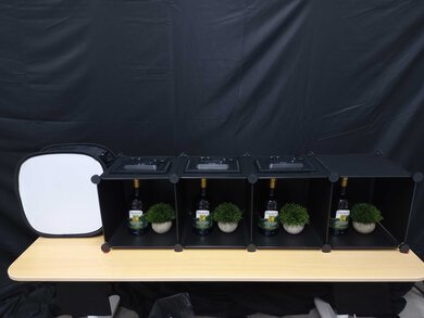 Image of a test scene with a softbox and four cubes, each containing a bottle and a fake plant