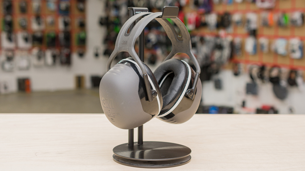 The 3M Peltor X5A earmuffs on a headphone stand.