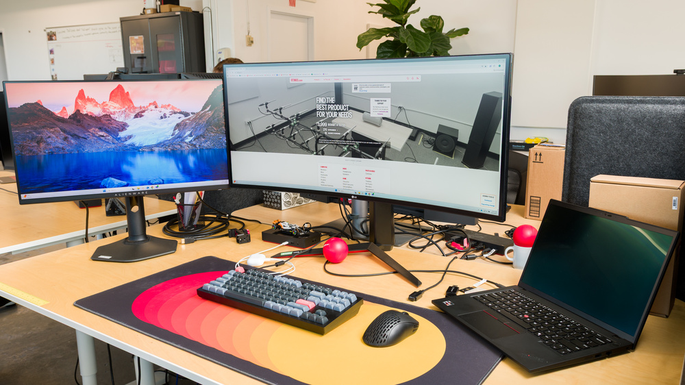 Two monitors on a desk next to each other.