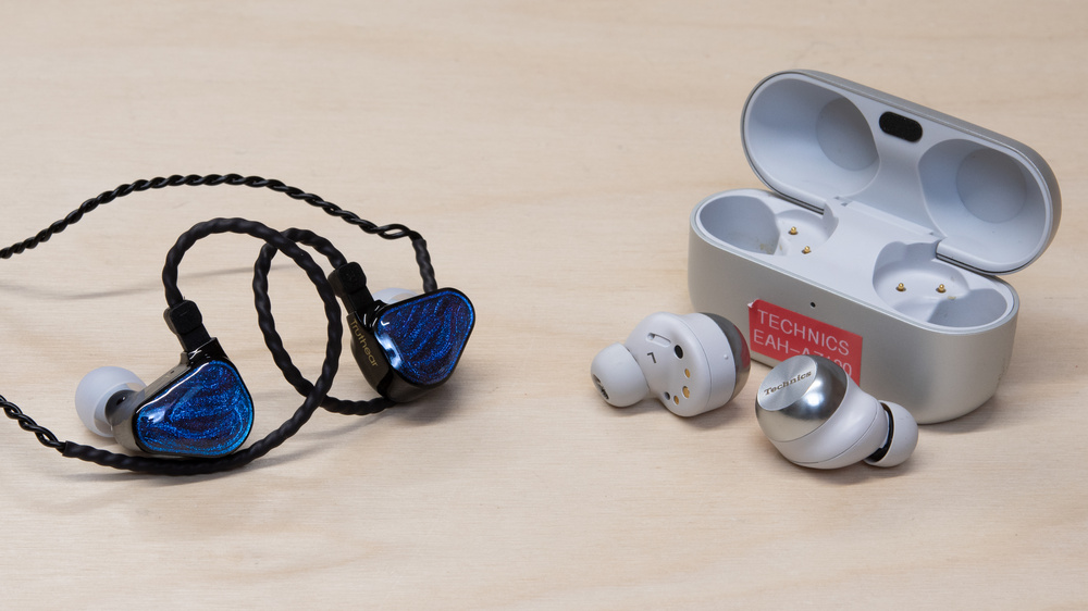 A pair of IEMs and wireless earbuds side by side.