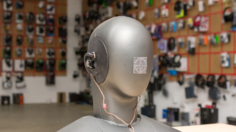 Picture illustrating how IEMs cable can be draped over the ear for a more secure fit.