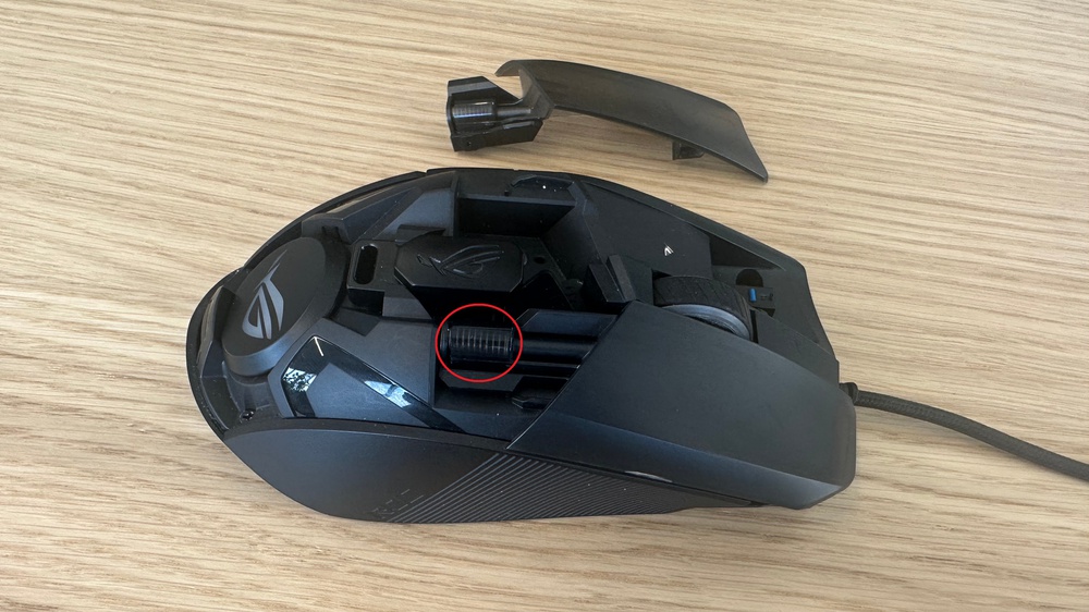 ASUS ROG Chakram Core with button removed and button spring highlighted.