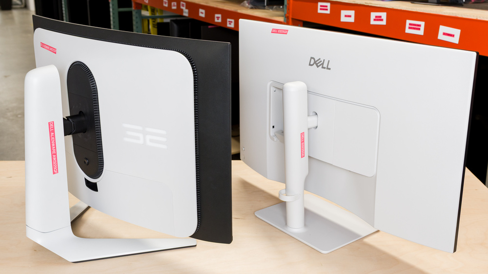 A curved monitor next to a flat one.