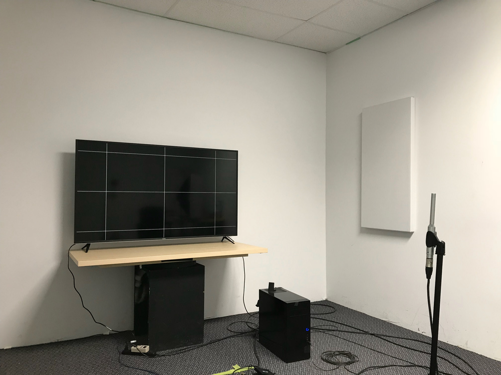 A TV placed along a wall, showing the microphone placement used for our audio quality testing.