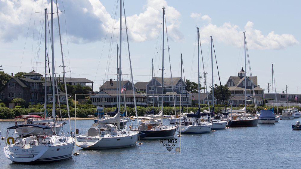 Our upscaling test image showing boats in a marina with some houses in the background