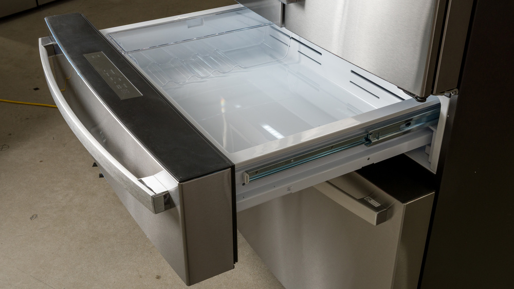An alternative full-width single pull-out drawer in a 5-door refrigerator. There's a control panel in the center of the drawer front top surface, and the drawer behind has a narrow full-depth tray in the drawer that you can move laterally.