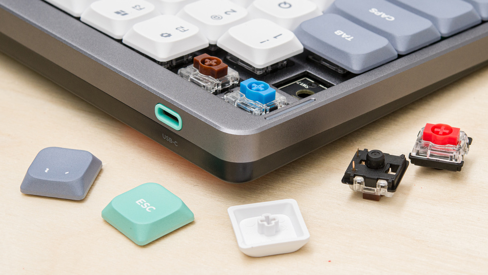 A photo of some keycaps sitting in front of a keyboard.