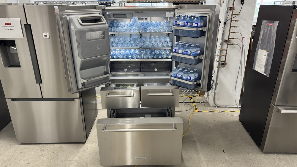 A 5-door refrigerator with the doors open, and drawers and freezer pull-out drawer extended. The fridge doors don't extend out very far, the pull-out drawers even less, but the freezer drawer extends out fairly far.