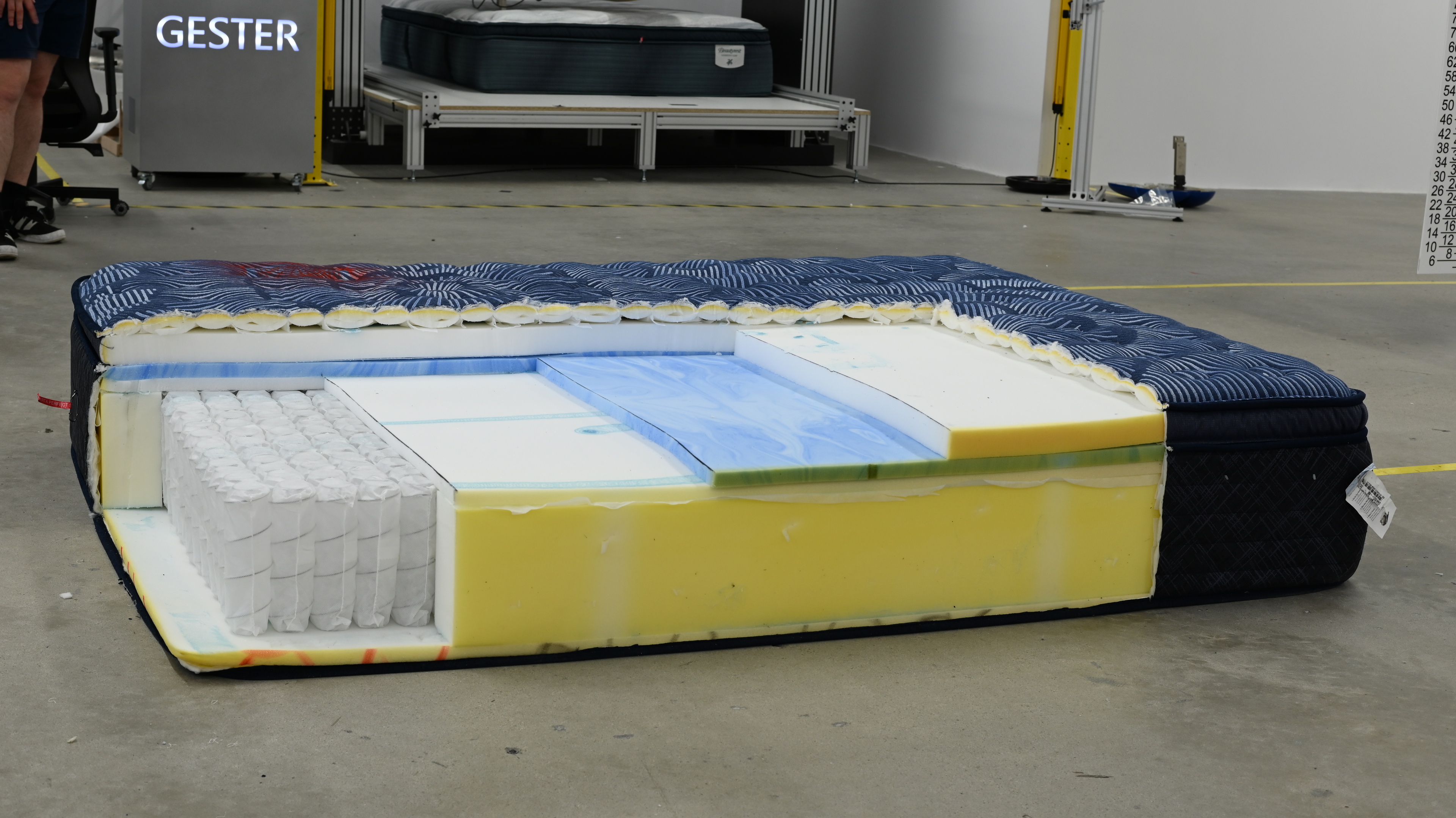 The Serta Perfect Innerspring on the floor, cut open so each layer is visible. There are pocket springs, and many layers of foam.
