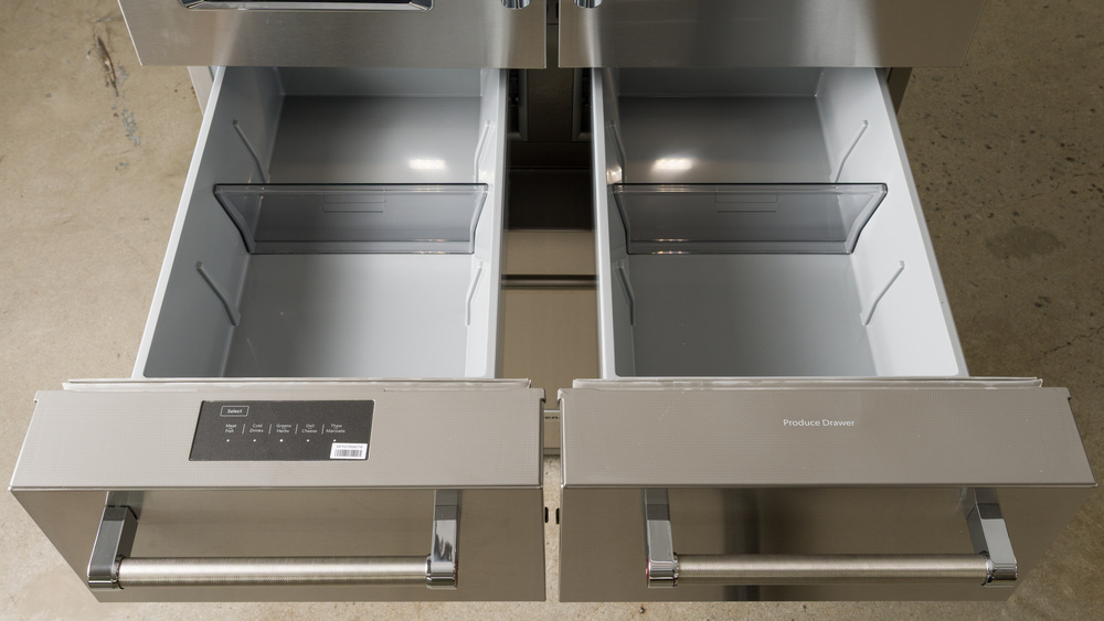 The separate pull-out drawers of a 5-door refrigerator. Each drawer's front is half-width, but the drawers themselves are narrower. The drawer on the left has a temperature control panel at the top inside surface, and there's a movable horizontal divider with three positions inside. The right drawer is labelled 'Produce Drawer' and has an identical horizontal divider arrangement.