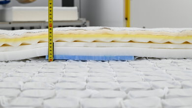 A close-up of the foam used in the Beautyrest Silver with a measuring tape to show how thick they are.