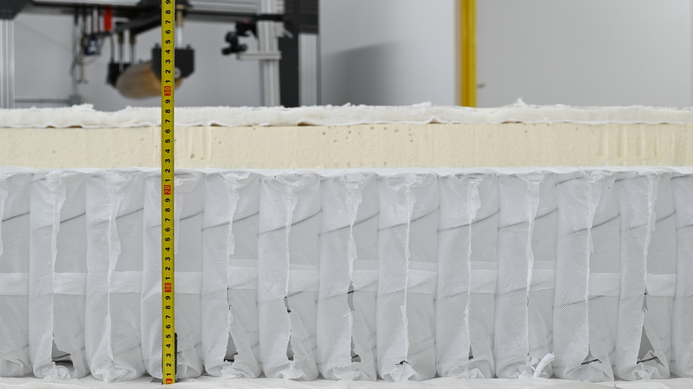 A photo showing the thickness of the Saatva Latex Hybrid Spring Layer.