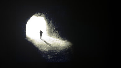 Test photo of a man staring at a cave opening on the Hisense QD7QF demonstrating the TV's low contrast ratio
