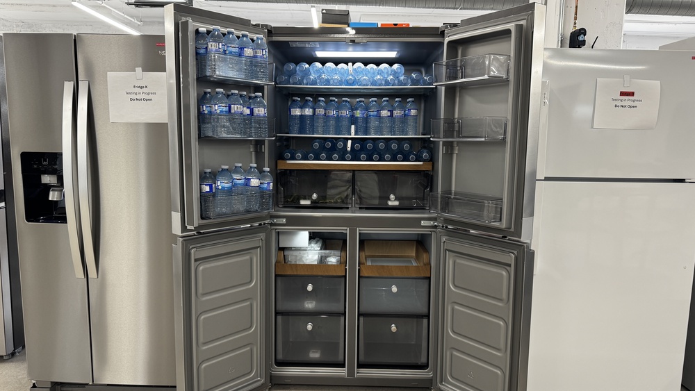 A 4-door refrigerator with the doors to both the fridge and freezer open. The doors are half-width and don't extend out very far. The drawers inside the fridge and freezer look like they might hit the inside of the doors if they were pulled out and the doors weren't opened 90 degrees or more.